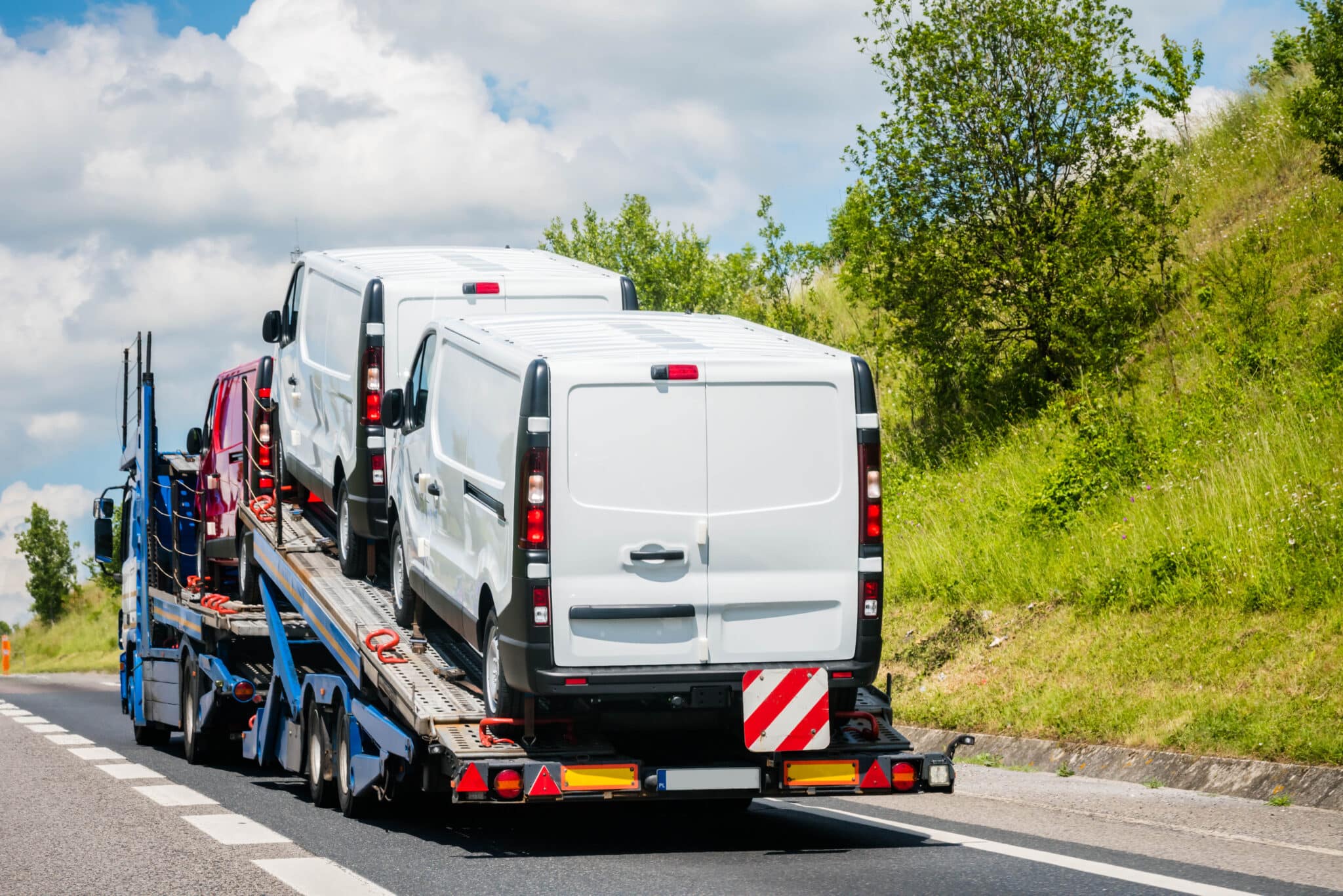 Truck transporting vans on the highway