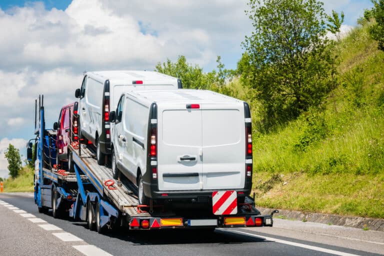 Truck transporting vans on the highway